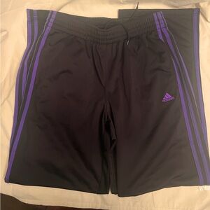 Adidas black track pants with purple stripes